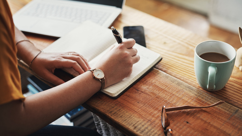 A person writing in a notebook