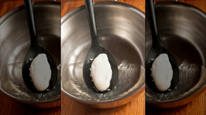Poached egg on a slotted spoon