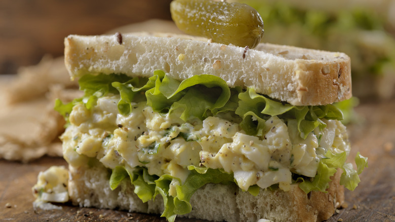 An egg salad sandwich with lettuce