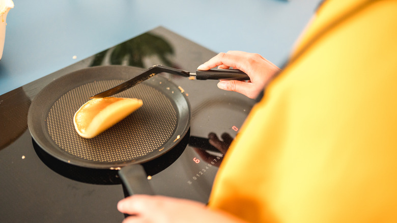 pressing pancake with spatula