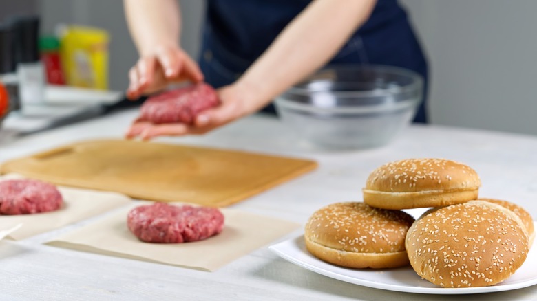 person making hamburger patties