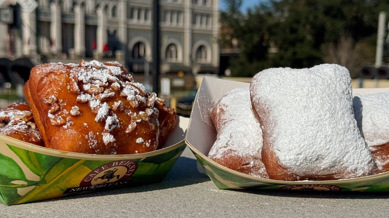 two different flavors of beignets in disposable containers