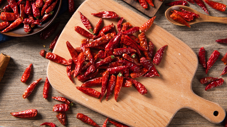 dried chili peppers on cutting board