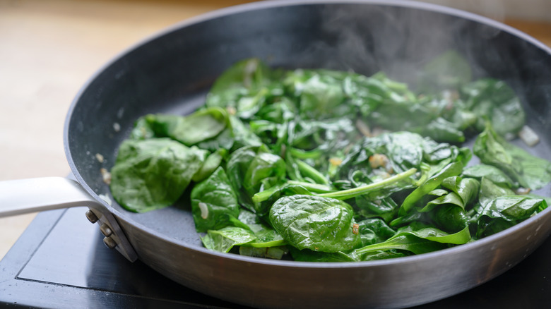 sautéing spinach in pan