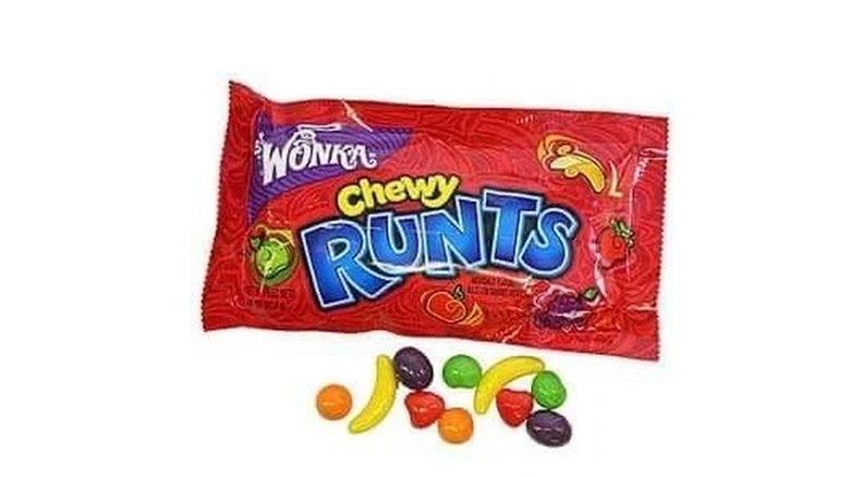 a packet of Wonka Chewy Runts on a white background, with some of the fruit candies in front