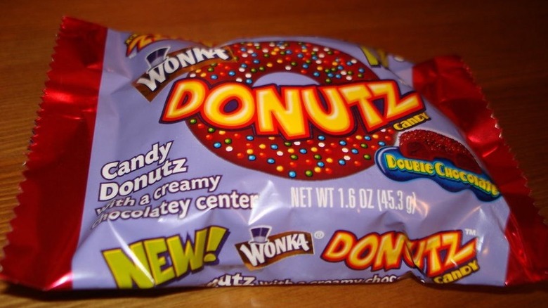 A packet of Wonka's Donutz candy on a wooden background