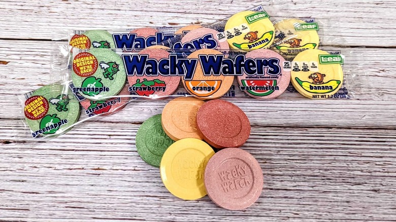 Three packets of Leaf's Wacky Wafers and five loose candies on a wooden background