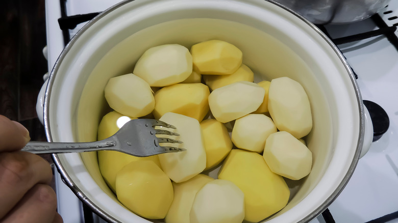 poking potatoes with fork