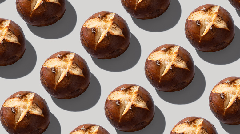 Pretzel buns arranged on a grey background