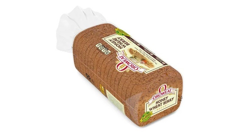 A bag of Oroweat Honey Wheat Berry bread on a white background