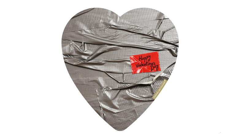 A top-down view of an Elmer heart-shaped box of chocolates with duct-tape decoration