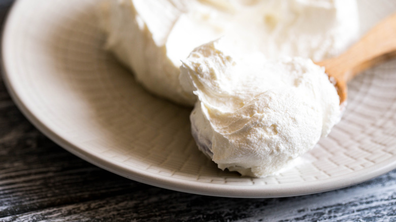 cream cheese on wooden spoon