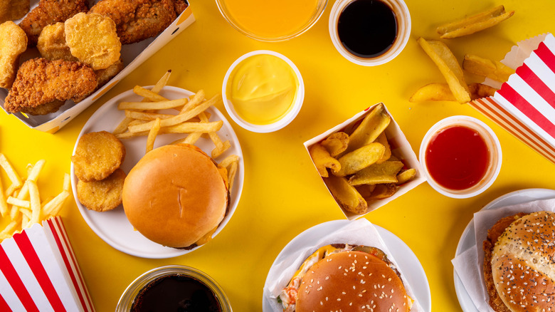 a top-down view of various fast food items, including burgers, fries, sauces and drinks