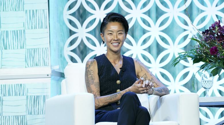 Kristen Kish smiling sitting in an interview chair on a set