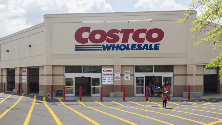 costco storefront with woan walking out