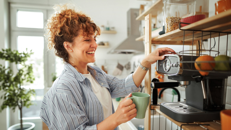 A woman making coffee in the kitchen