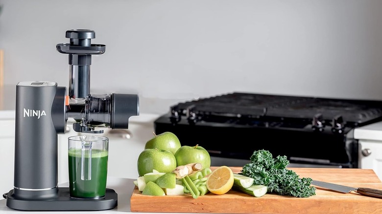 A Ninja NeverClog Cold Press Juicer with fruits and vegetables