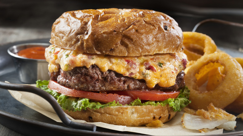 cheeseburger and onion rings on plate