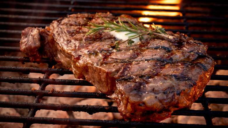 Grilled steak on grill grate