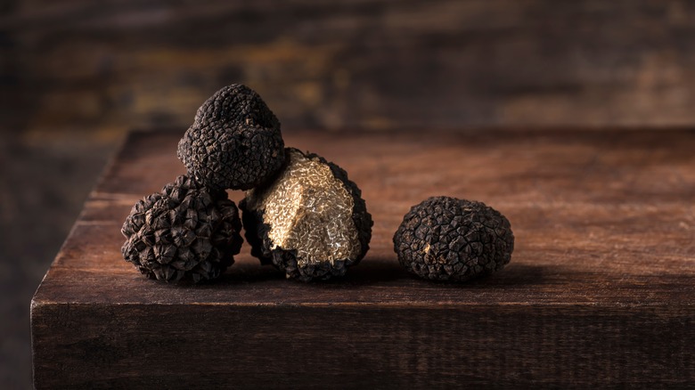 black truffles on wooden table