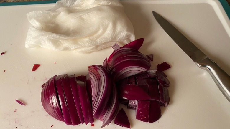 Red onion white cutting board paper towel