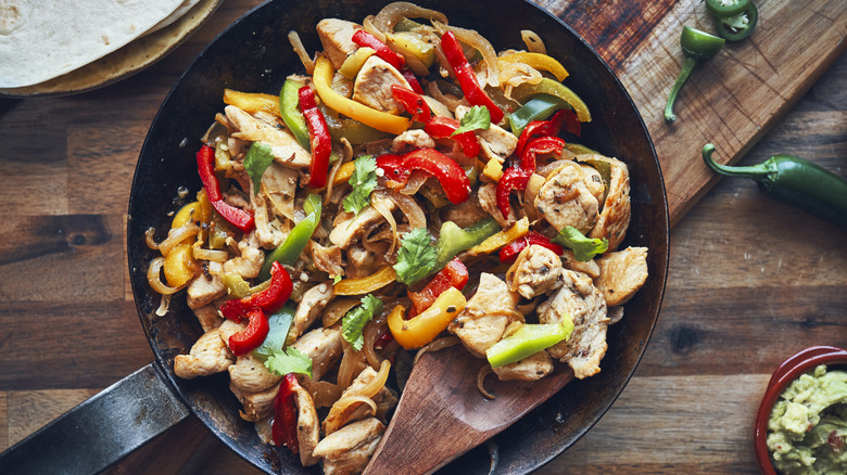 Bell peppers and chicken in a skillet