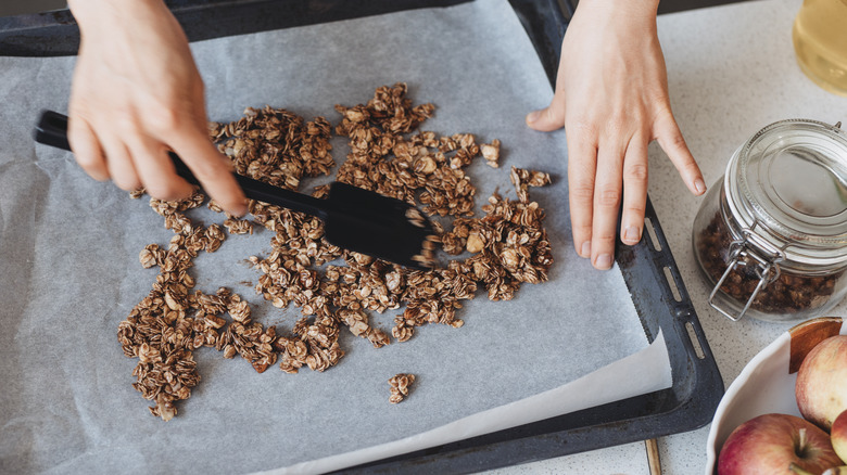 granola being prepared on baking sheet