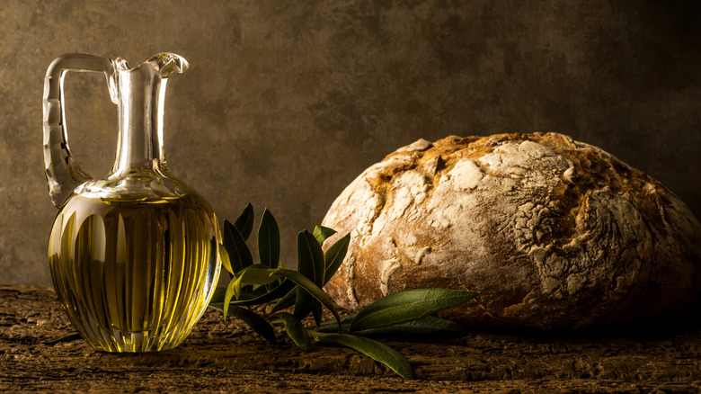 Olive oil jar and fresh bread loaf