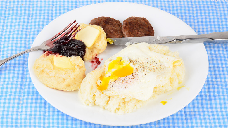 Fried egg served over grits with sausage