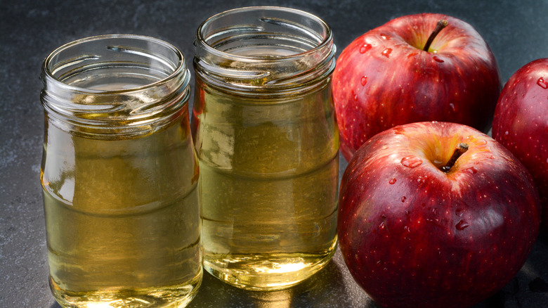 Two glass jars of apple cider vinegar