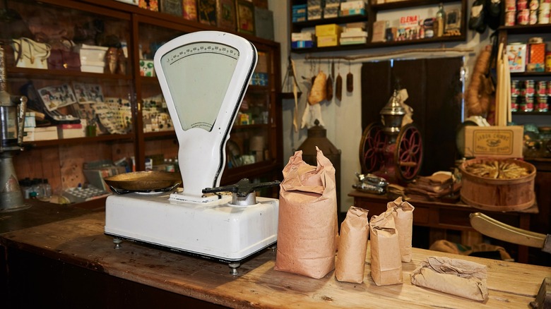 Vintage grocery store scale on wood counter in dated establishment