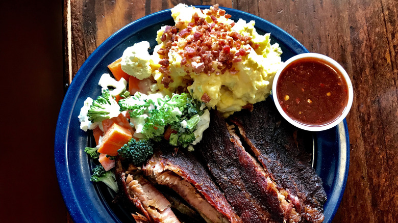 Potato salad and meats, veggies, with spicy BBQ sauce