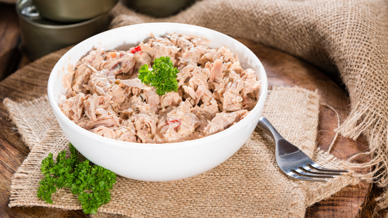 Tuna salad in a white bowl with a fork