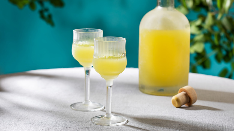 A bottle with two glasses of Limoncello