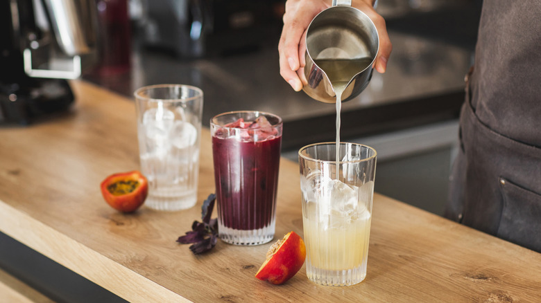 Liquid poured into glass of juice and ice