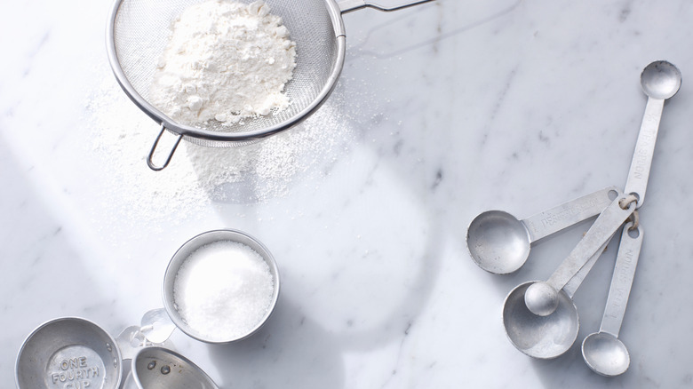 Kitchen tools and powdered sugar.