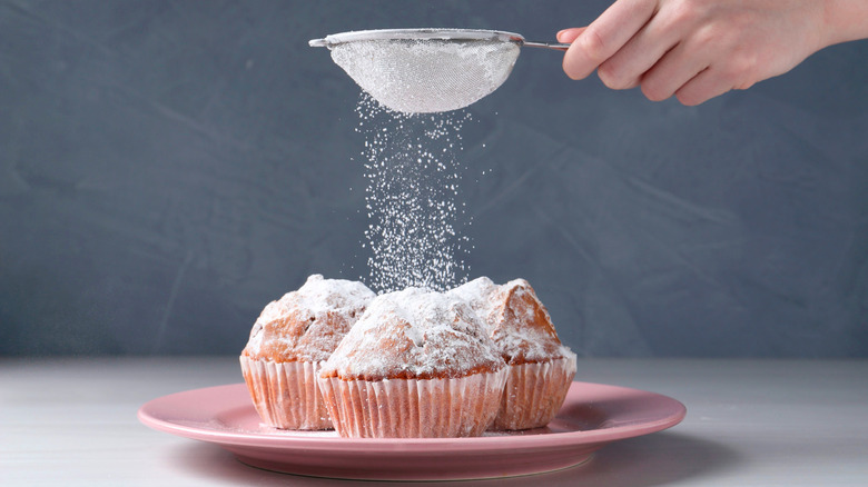 Dusting pastries with powdered sugar.