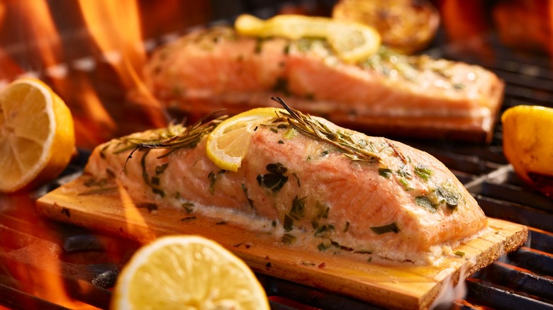 Salmon on cedar plank over flaming grill