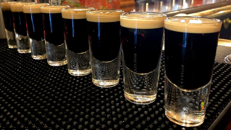 Baby Guinness shots lined up on a bar