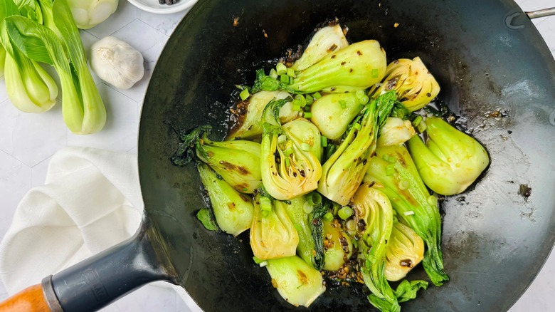 cooked bok choy in a black wok