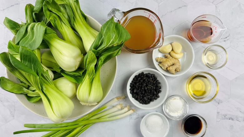 raw bok choy with broth and seasonings