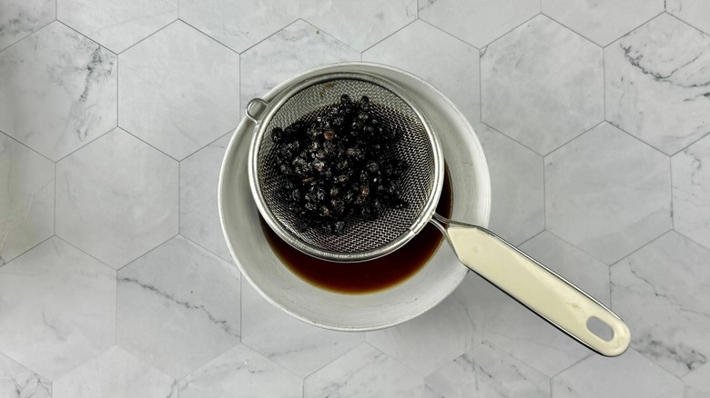 fermented black beans in a strainer