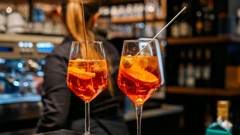 Two Aperol Spritz drinks in wine glasses