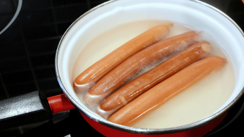 Frankfurter sausages simmering in water