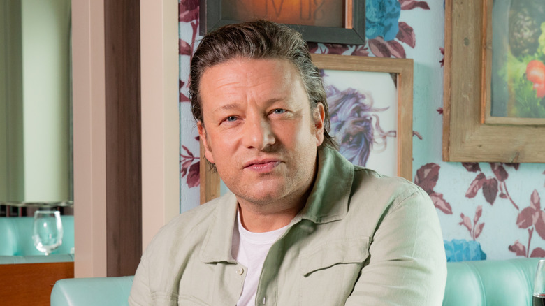 Chef Jamie Oliver, wearing a light green shirt over a white t-shirt