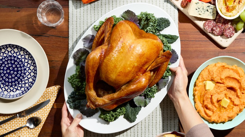 Thanksgiving turkey on platter with side dishes