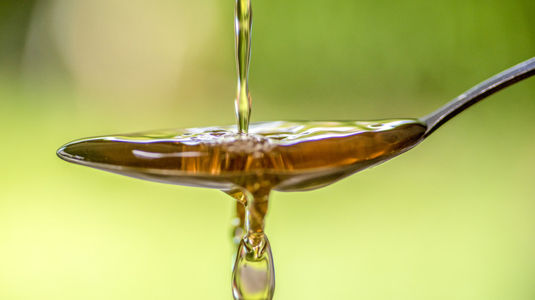 Close-up pouring vinegar onto a spoon