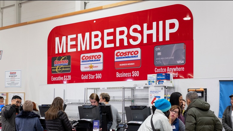 Costco membership counter with employees and customers