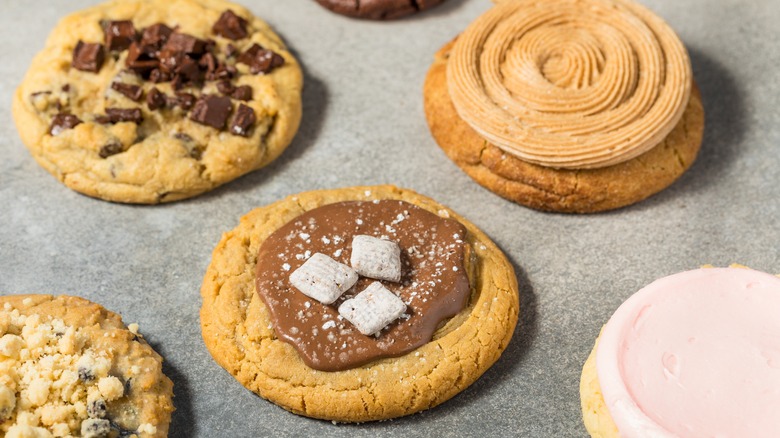 Assorted Crumbl cookies line a countertop