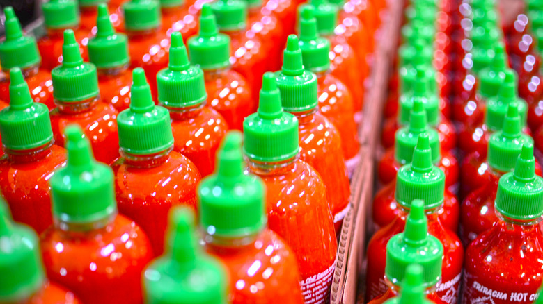 Bottles of sriracha sauce with green cap